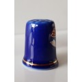 A Vintage collectors thimble. Thimble in blue glaze, painted flower in front