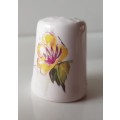 A Vintage collectors thimble. A white ceramic Thimble with painted flower in front.