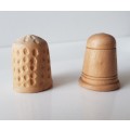 A Vintage collectors set of two wooden thimbles. Two Hand crafted wooden Thimbles.