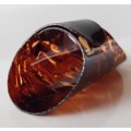 A Vintage collectors Perspex plastic thimble. Thimble is brown coloured plastic & expandable rinG