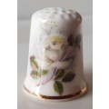 A Vintage collectors thimble. Thimble has painted roses in front