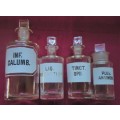 FOUR VINTAGE CLEAR GLASS CHEMIST-APOTHECARY BOTTLES + GLASS STOPPERS & WHITE LABELS  (LOG) SEE PICS