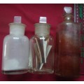 THREE DIFFERENT SIZE CLEAR GLASS VINTAGE CHEMIST-APOTHECARY BOTTLES WITH GLASS STOPPERS -SEE PHOTOS