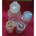FOUR DIFFERENT ROUND CLEAR VINTAGE CHEMIST-APOTHECARY BOTTLES-SEE PHOTOS