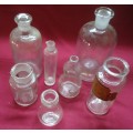 SEVEN DIFFERENT ROUND CLEAR VINTAGE CHEMIST-APOTHECARY BOTTLES-SEE PHOTOS