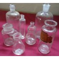 SEVEN DIFFERENT ROUND CLEAR VINTAGE CHEMIST-APOTHECARY BOTTLES-SEE PHOTOS
