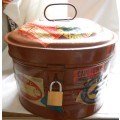 VINTAGE BROWN OVAL TIN HAT BOX WITH BAGGAGE LABELS