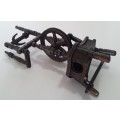 A vintage, collectable metal spinning wheel pencil sharpener.