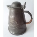 Antique Arts and Crafts pewter jug in the style of Liberty and Co. Hand-beaten lily pattern.