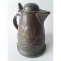Antique Arts and Crafts pewter jug in the style of Liberty and Co. Hand-beaten lily pattern.