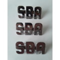 3 x SBA metal shoulder titles. Lugs intact.