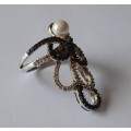 `Reserved`. A Vintage Solid Sterling Silver Swirl Design Pearl Ring With Clear And Black Stones.