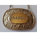 A Vintage Silver Plated `BRANDY` Bottle Decanter Label By `Ianthe, England`.