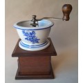 Vintage Coffee Grinder With Blue And White Ceramic Top In the Delft Style.