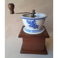 Vintage Coffee Grinder With Blue And White Ceramic Top In the Delft Style.