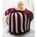 Vintage knitted doll tea cosy