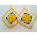 Kitsch is king! Crocheted potholders with beautiful yellow flowers.