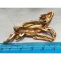 Gold coloured Brooch with two enameled leaping deer
