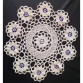 Lovely beige crocheted doily with purple flowers - about 38cms across