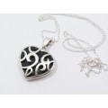 A Lovely Revisable Filigree Heart Pendant With a Black Acrylic Backing On Chain in Sterling Silver.