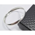 A Lovely Broad D Shape Bangle in Sterling Silver.