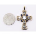 A beautiful, handmade 9 carat gold cross pendant, set with lovely light blue topaz gemstones