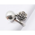 A Beautiful Open Ended Ring With a Flower on the One Side And a Ball on the Other in Sterling S
