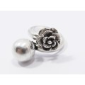 A Beautiful Open Ended Ring With a Flower on the One Side And a Ball on the Other in Sterling S