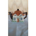 A hand painted cottage teapot