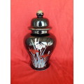 A beautiful decorative ginger jar and candlestick holder set