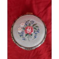 A petit point embroidered powder box