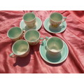 Susie Cooper.  Three saucers and six, SMALL, coffee cups.  No chips, cracks or repairs.