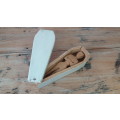 A wooden carving of a man in a box, shaped like a coffin, 25cm 9cm x 6cm
