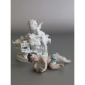 Vintage lot of 2 Porcelain Figurines; Angel with Bird and Cat, 13cm, Cherub holding flowers, 14cm