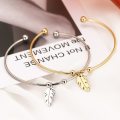 RETAIL PRICE: R 999 Adjustable Titanium "Whimsical Feather" Charm Bangle (SILVER)