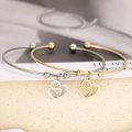 RETAIL PRICE: R 999 Adjustable Titanium "Hearts" Charm Bangle (GOLD )