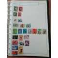 Stamp album, full of hinged stamps.