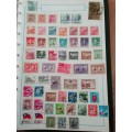 Stamp album, full of hinged stamps.