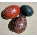THREE COLOURFUL ALABASTER, MARBLE OR ROCK EGGS