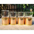 FOUR LIQUEUR GLASSES WITH COPPER AND BRASS METAL HOLDERS FEATURING A LOCK LOOP BRASS HANDLE
