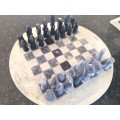 Soap stone chess set and board.