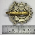 The Bedfordshire and Hertfordshire regiment cap badge with slide
