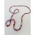 Long red Aurora Borealis bead necklace