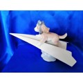 Lladro 6665 `Let`s Fly Away` goggled puppy dog on a paper airplane
