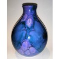 A stunning blend of blue, indigo and violet glazes, this eye-catching Vase by Poole