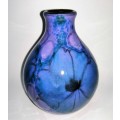 A stunning blend of blue, indigo and violet glazes, this eye-catching Vase by Poole