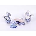 Four blue and white faience wares, comprising: inkwell, pair of condiment ewers and twin-bowl