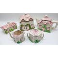 Five cottage porcelain wares, comprising: teapot, milk jug, sugar bowl. butter dish and biscuit jar