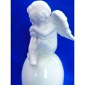Continental blanc de chine Bell with Cherub sat on top