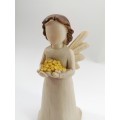 Willow Tree style wooden angel holding yellow flowers